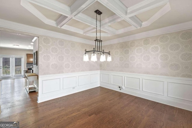 unfurnished dining area with dark hardwood / wood-style floors, ornamental molding, and coffered ceiling