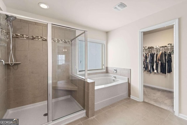 bathroom with separate shower and tub and tile patterned floors