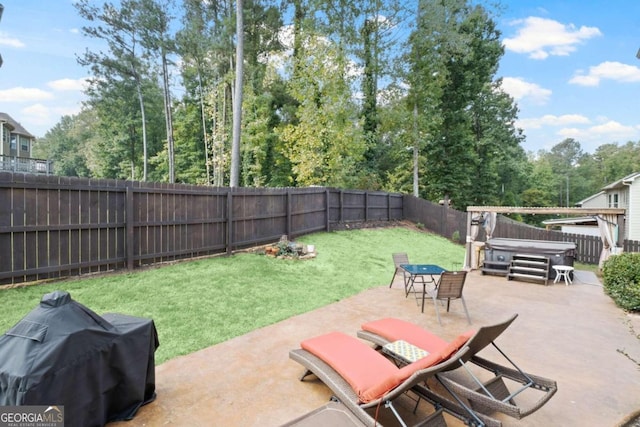 view of patio / terrace with area for grilling and a hot tub