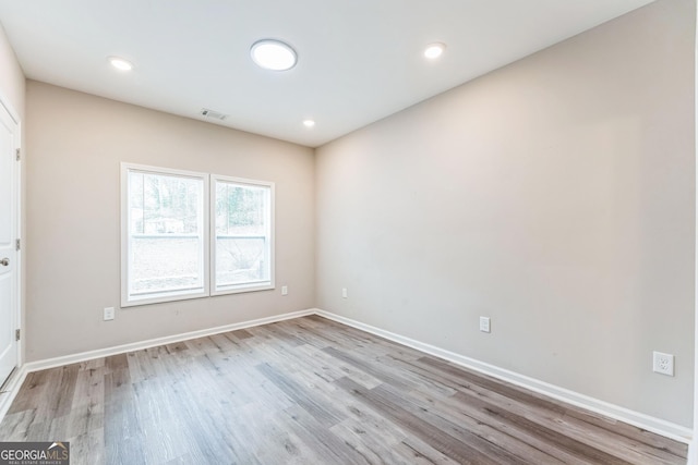 empty room with light hardwood / wood-style flooring