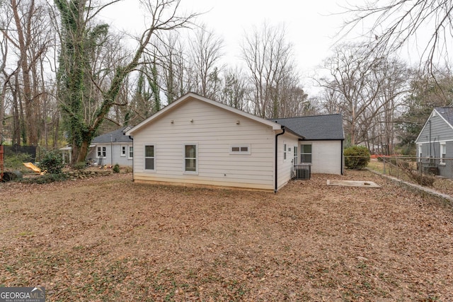 rear view of house with central AC unit