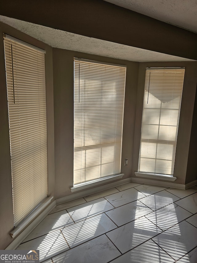 empty room with a textured ceiling