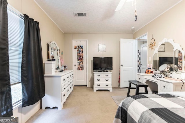 carpeted bedroom with ornamental molding, multiple windows, and a textured ceiling