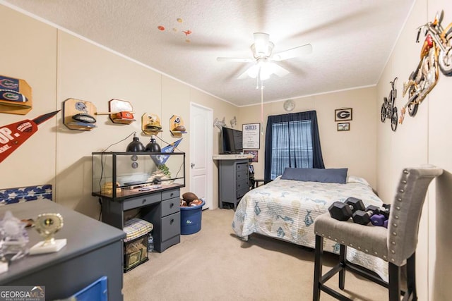 carpeted bedroom with a textured ceiling, ceiling fan, and crown molding