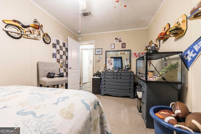 carpeted bedroom with ceiling fan, a textured ceiling, and crown molding