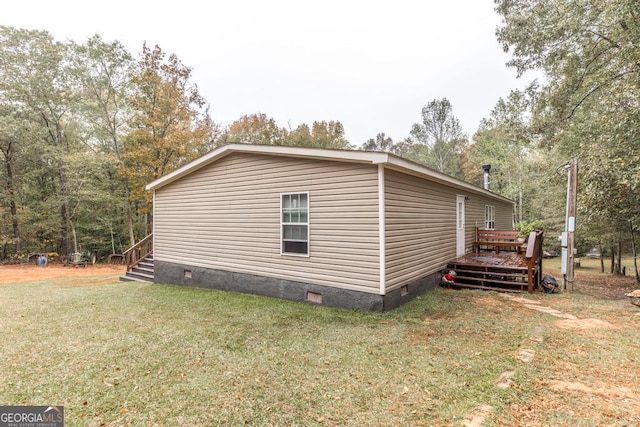 view of side of home with a lawn and a deck