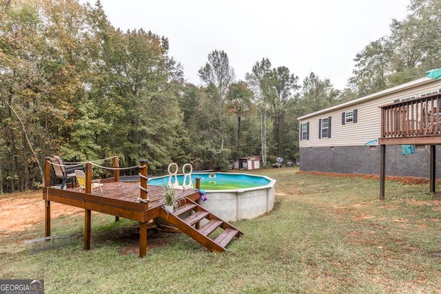 view of pool with a deck and a yard