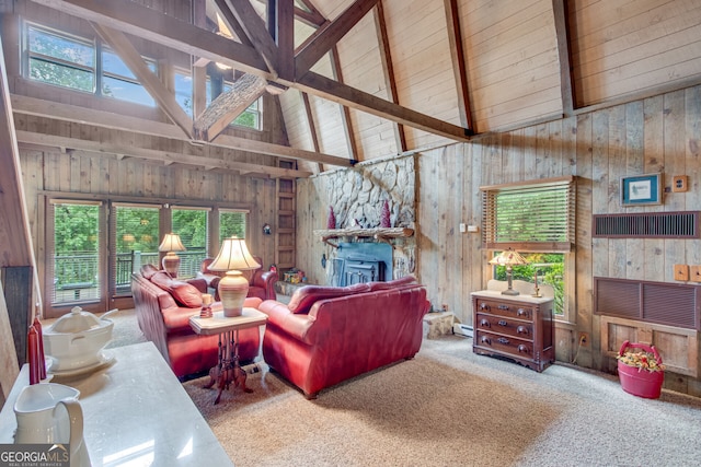 carpeted living room with wood walls, beamed ceiling, plenty of natural light, and high vaulted ceiling