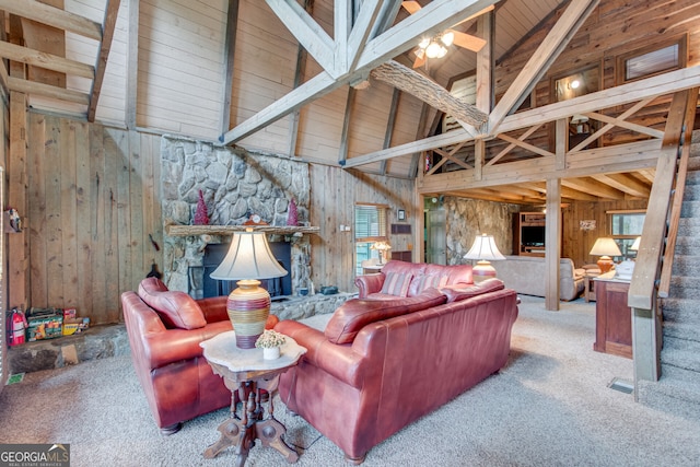 carpeted living room featuring high vaulted ceiling, wood walls, beam ceiling, and plenty of natural light