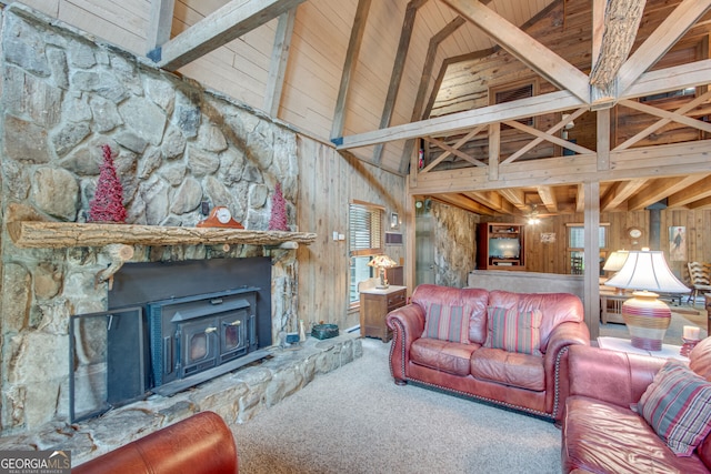 carpeted living room with beamed ceiling, wooden walls, a wood stove, and high vaulted ceiling