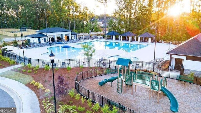 view of swimming pool featuring a patio area and a playground