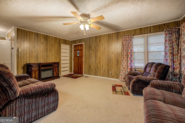 living room featuring wood walls, a textured ceiling, and ceiling fan