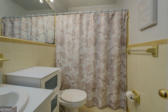 bathroom with tile walls, vanity, and toilet