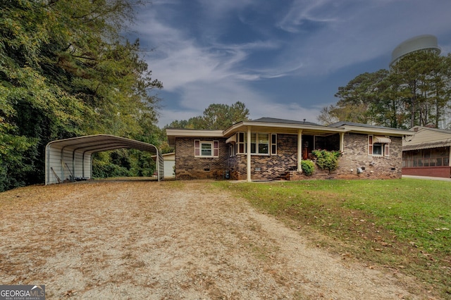 ranch-style home with a front yard and a carport