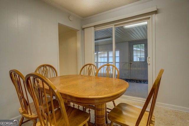 tiled dining room featuring crown molding