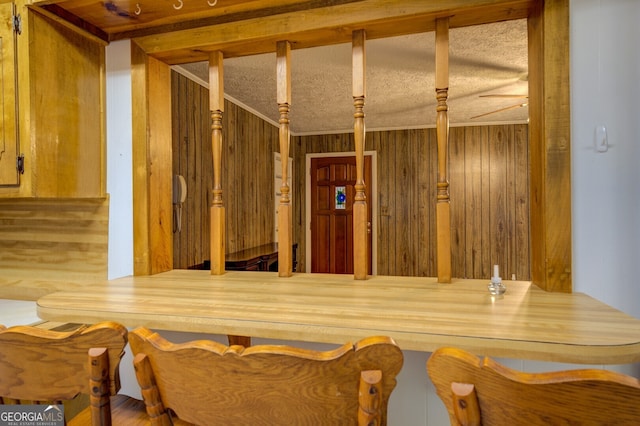 interior space with wood walls and ceiling fan