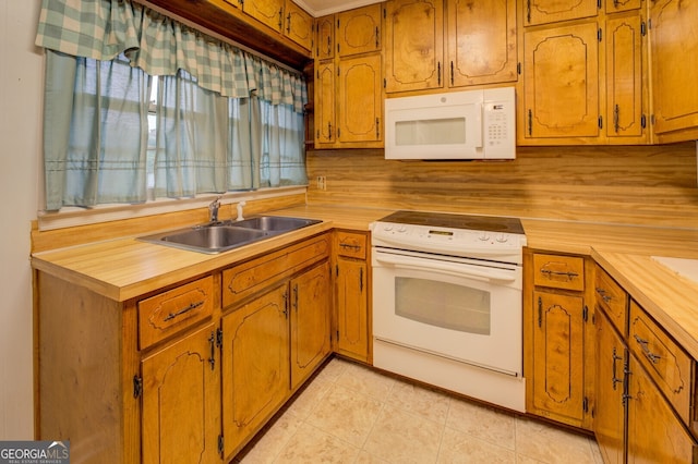 kitchen featuring sink, white appliances, backsplash, and light tile patterned floors