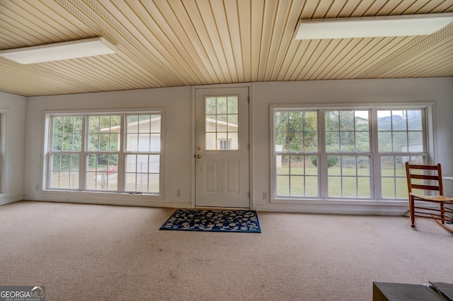 entryway featuring wooden ceiling and carpet floors