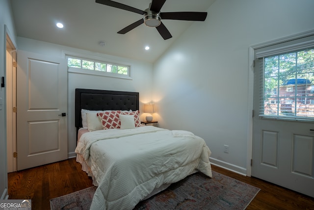 bedroom with ceiling fan, dark hardwood / wood-style floors, and vaulted ceiling