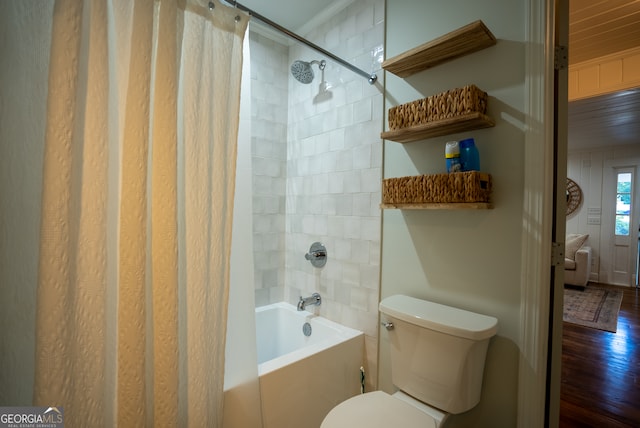 bathroom featuring crown molding, hardwood / wood-style floors, shower / bath combo with shower curtain, and toilet