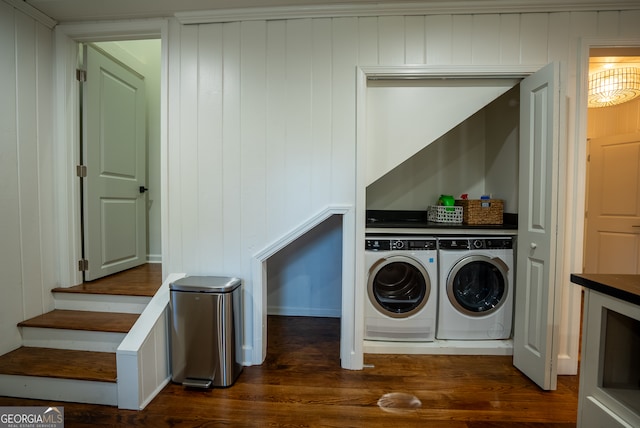 clothes washing area featuring dark wood-type flooring and washing machine and dryer