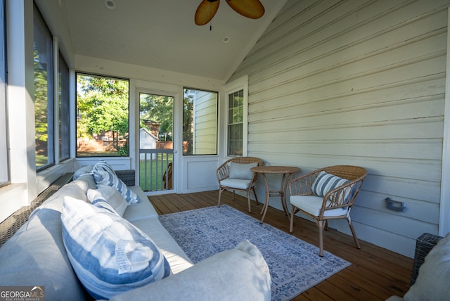 sunroom featuring lofted ceiling and ceiling fan