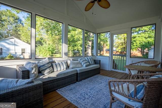 sunroom / solarium with ceiling fan and vaulted ceiling