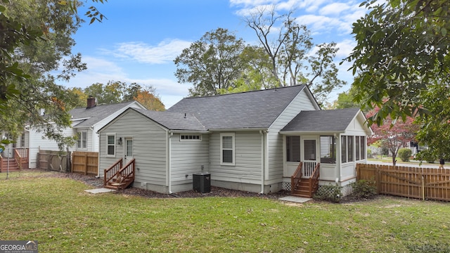 back of house with a lawn and a sunroom