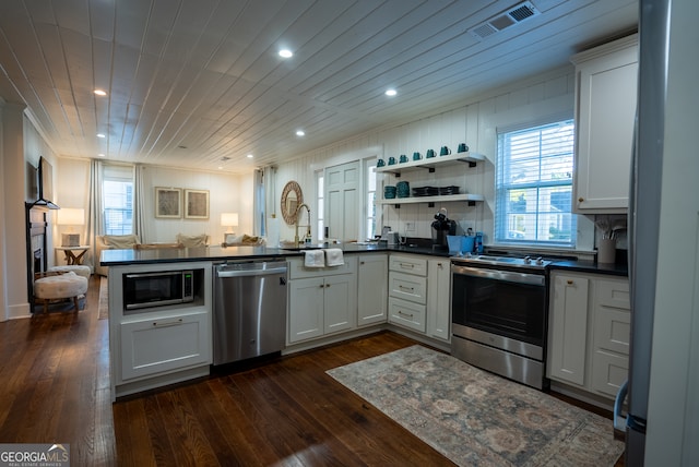 kitchen featuring stainless steel appliances, dark hardwood / wood-style floors, and white cabinets