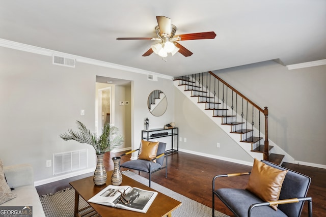 living room with dark hardwood / wood-style flooring, ceiling fan, and crown molding