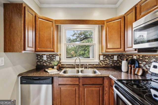 kitchen featuring decorative backsplash, stainless steel appliances, ornamental molding, and sink