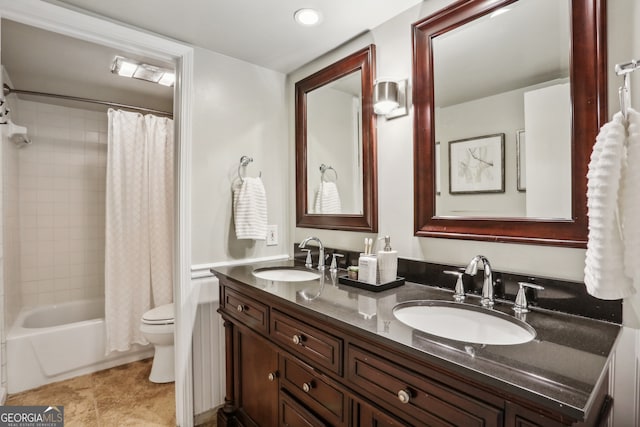 full bathroom featuring shower / bath combo, vanity, and toilet