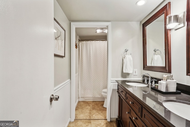 bathroom featuring tile patterned flooring, vanity, and toilet