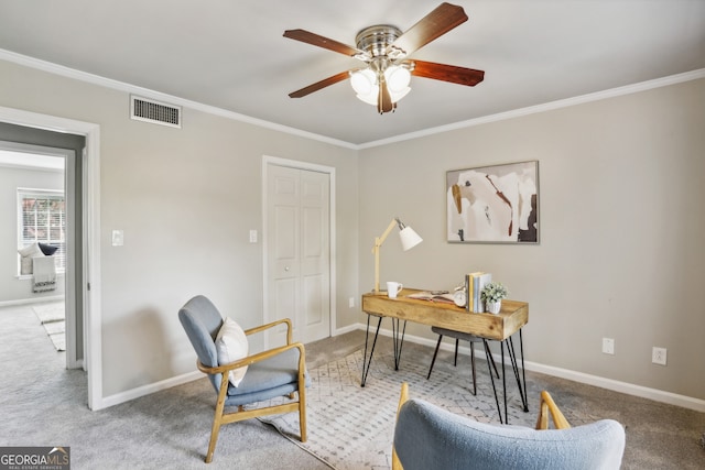 carpeted home office with ceiling fan and crown molding