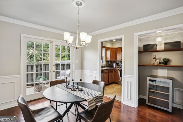 dining space with hardwood / wood-style floors, french doors, crown molding, wine cooler, and a chandelier