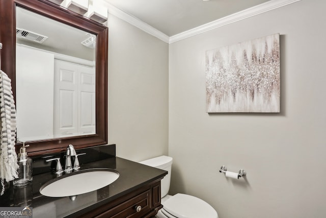 bathroom featuring vanity, toilet, and crown molding