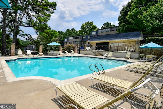 view of swimming pool featuring a patio area