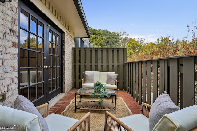 balcony featuring outdoor lounge area, french doors, and a patio area