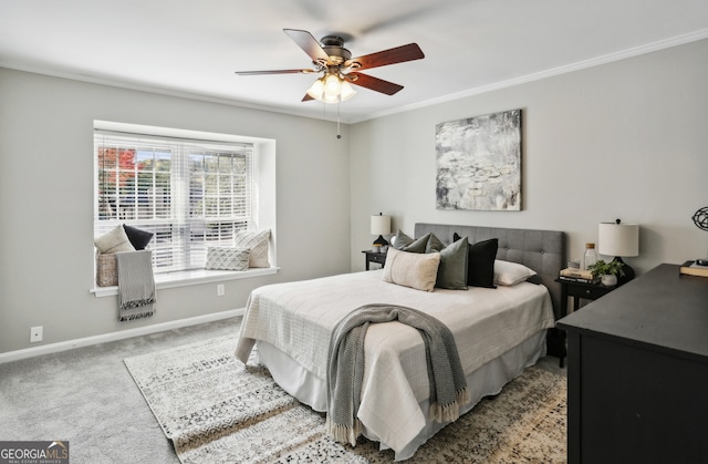 carpeted bedroom with ceiling fan and ornamental molding