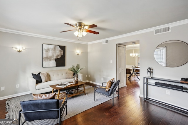 living room with ceiling fan with notable chandelier, dark hardwood / wood-style floors, and crown molding