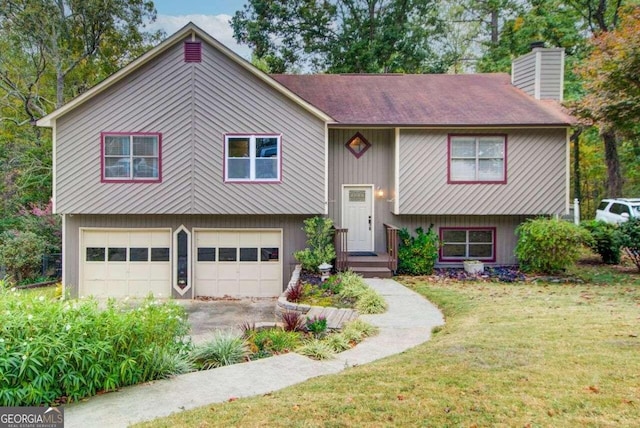 raised ranch with a garage and a front yard