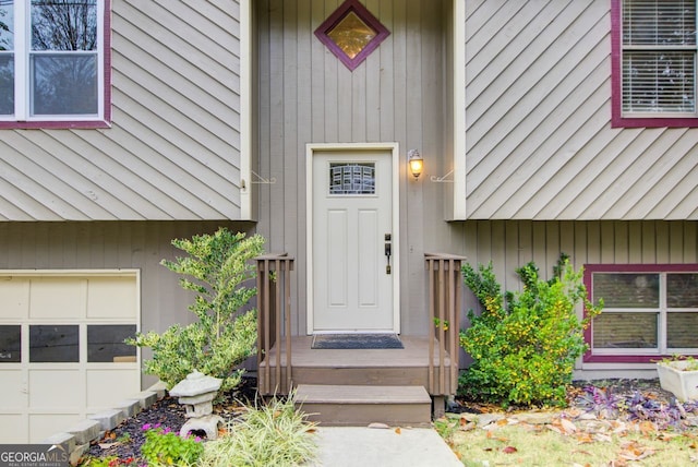 doorway to property with a garage