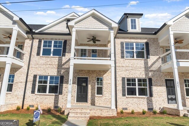 townhome / multi-family property with ceiling fan and a balcony