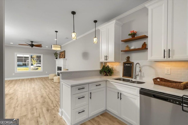 319 S Madison Ave, Monroe, GA 30655 - kitchen featuring dishwasher, a sink, a fireplace, tasteful backsplash, and crown molding