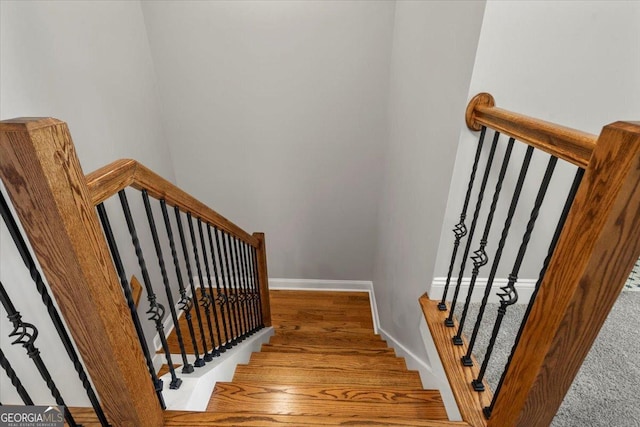319 S Madison Ave, Monroe, GA 30655 - staircase featuring baseboards and wood finished floors