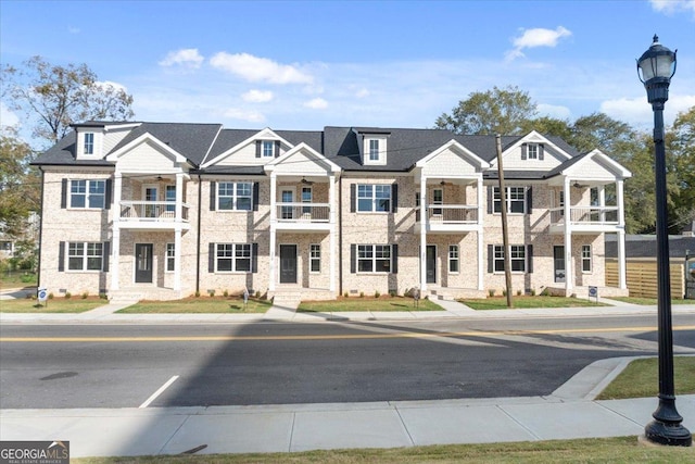 319 S Madison Ave, Monroe, GA 30655 - view of property with a balcony, ceiling fan, and brick siding