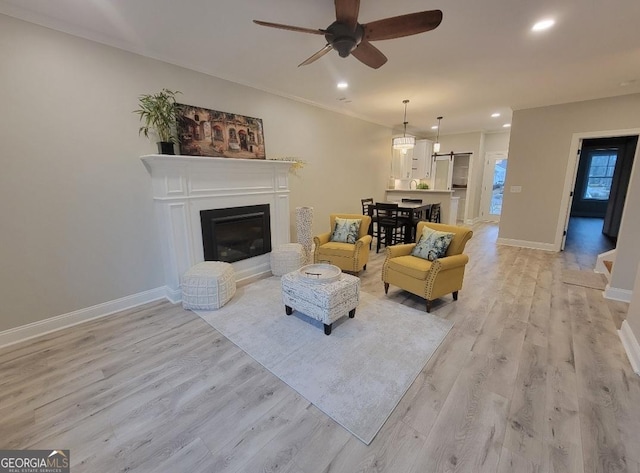 319 S Madison Ave, Monroe, GA 30655 - living area with ceiling fan, light wood-type flooring, recessed lighting, baseboards, and a glass covered fireplace