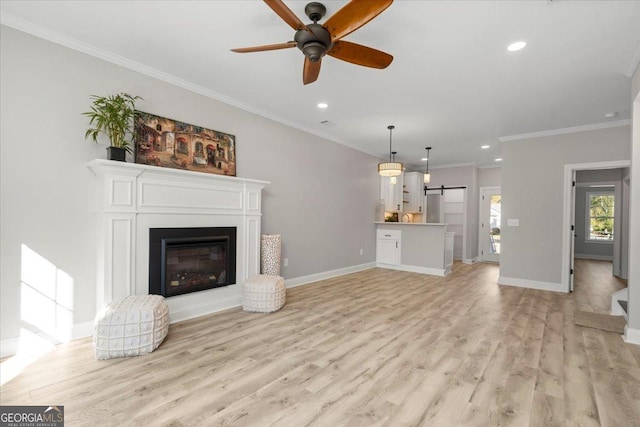 319 S Madison Ave, Monroe, GA 30655 - unfurnished living room featuring recessed lighting, a ceiling fan, a barn door, light wood finished floors, and ornamental molding