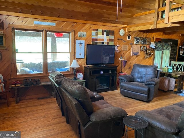 living room featuring wood walls, hardwood / wood-style floors, and wooden ceiling