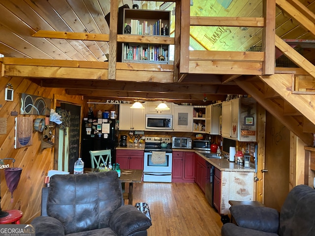 kitchen with black appliances, light wood-type flooring, wood walls, beamed ceiling, and wooden ceiling